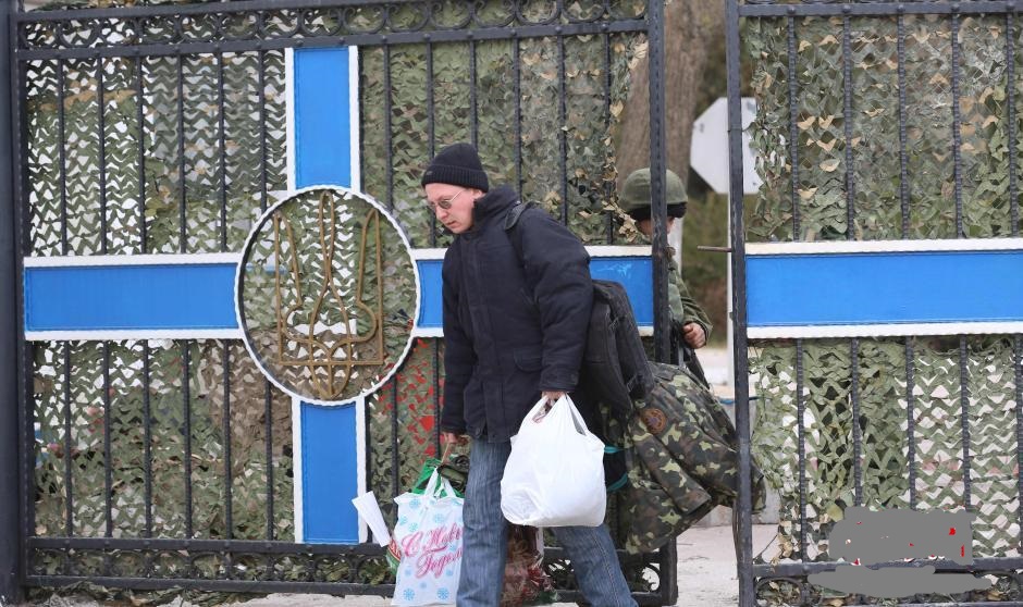 烏克蘭海軍司令部易手 部分官兵脫下軍裝離去<br />2014年03月20日 04:15　<br /><br /><br />辛菲羅波爾3月19日電 題：烏克蘭海軍司令部易手 部分官兵脫下軍裝離去<br />　　<br />　　隨著俄羅斯總統普京18日宣佈克裡米亞成為俄聯邦的一部分，克裡米亞半島上的烏克蘭軍隊壓力陡然增大。儘管烏克蘭方面表示，允許其在半島上的駐軍使用武器，但這並不能改變烏軍受到親俄民眾的“重點關照”的命運。<br />　　據烏克蘭國家通訊社19日報導，當地時間早8點左右，位於克裡米亞半島南部城市塞瓦斯托波爾的烏克蘭海軍司令部遭到約200名親俄民眾的衝擊。隨後趕來的身份不明武裝人員則與烏克蘭海軍官兵對峙。<br />　　烏克蘭海軍司令部被佔領<br />　　當記者從克裡米亞首府辛菲羅波爾趕到塞瓦斯托波爾後，親俄民眾與未知身份的武裝人員已經控制了該司令部。記者在事發地看到，烏克蘭海軍司令部樓頂上的烏克蘭國旗已被摘下，換上了俄羅斯國旗。<br />　　記者看到，烏海軍司令部大門處站著5名身份不明的武裝人員和十幾名親俄民眾。透過大門可以看到，司令部院子裡面有十幾名身穿迷彩服的“自衛隊員”和幾名武裝人員在巡邏。<br />　　一位名叫薩沙的中年男子看到了早上發生的事情。他告訴中新社記者，起初民眾只是用擴音器向基地內的烏克蘭軍人喊話，希望他們放棄武裝並離開司令部。但“一名烏克蘭軍官下令用鐵鍊鎖死大門，不准任何士兵從司令部出去”。此舉激怒了現場的民眾，“民眾推倒了司令部的鐵柵欄牆並進入司令部院子”。<br />　　記者看到，烏海軍司令部大門旁邊的鐵柵欄已經倒掉，其原來位置被安置了兩架鐵絲網。另有媒體報導，民眾是“開拖拉機撞開的鐵柵欄”。但該說法沒有得到其他在場民眾的證實。<br />　　薩沙表示，“烏克蘭軍人並沒有使用武器”。“起初只是試圖用‘人牆’阻止民眾湧入，但很快就被沖散”。“在民眾進入烏海軍司令部後，武裝人員也隨後進入”。<br />　　此外，薩沙提到，烏海軍司令部司令加杜克已經離開該司令部，去向不明。<br />　　記者看到，雖然烏海軍司令部院子裡有未知武裝人員在巡邏，但同時也能看到沒有武裝的烏克蘭海軍士兵的活動。一位烏克蘭海軍軍官走出大門對媒體表示，“上午沒有發生什麼不愉快的事情”，“我現在依然向往常一樣工作”。<br />　　一小時7、8名烏克蘭官兵離隊<br />　　該名目擊者透露，到目前為止，該司令部已有“很多軍官和士兵選擇了離開，沒有人阻止他們”。記者在現場看到，大約一個小時內，先後有7、8名烏克蘭海軍官兵手持軍裝，背著大包小包離開該司令部。他們的舉動受到了司令部外面親俄民眾的歡迎。<br />　　其中一位脫下軍裝的烏克蘭海軍上尉告訴記者，“俄羅斯軍方已經承諾，等局勢穩定後就可以恢復我的工作”。另一位脫下軍裝的烏克蘭海軍士兵則表示，自己是塞瓦斯托波爾人，不想為“外國軍隊”服役。<br />　　季馬是一位去年剛從烏克蘭海軍退役的俄羅斯族士兵，曾在該司令部服役一年多。他告訴記者，一般選擇離開的官兵都是克裡米亞人，“不離開的一般都是烏克蘭其他地區的人”。<br />　　他表示，烏克蘭海軍其實“士氣一直不高”，因此受到衝擊後“不堅定”。“一個重要的因素是收入”，“在塞瓦斯托波爾的俄羅斯黑海艦隊一個上尉每個月即使不算駐外補助，收入也在3000美元左右，而同等級別的烏克蘭黑海艦隊軍官收入只有450美元，相差好幾倍”。“雙方都在一個城市服役，說相同語言，一比較烏克蘭海軍軍人很容易產生別的想法”。